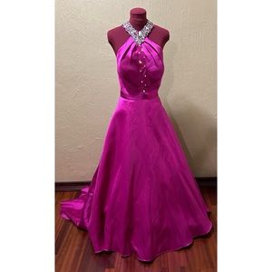 This vibrant fuchsia gown has silver stones embellishment around the neck-chest